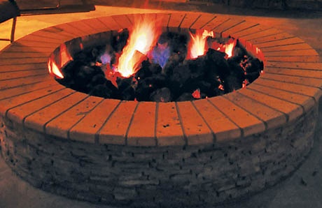 Fire pit topped with curved bullnose stone
