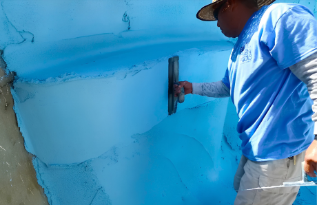 Blue Haven worker applying plaster finish to interior of gunite swimming pool