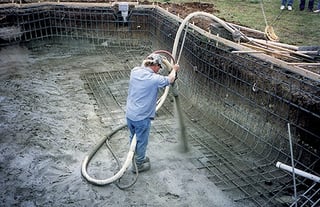 gunite-specialist-applying-materials-with-hose-1.jpg