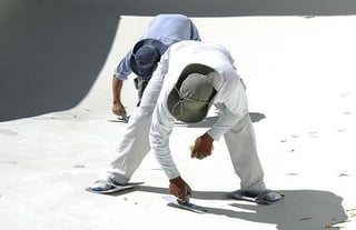 men-applying-plaster-to-inground-pool.jpg