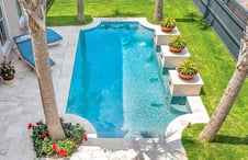 Custom-Grecian-pool-with-travertine-deck