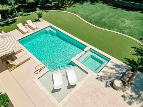 Blue Haven gunite pool with raised spa and integrated tanning ledge seating