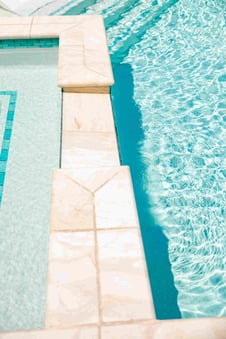 Blue Haven gunite pool coping and waterline tile detail with clear blue water