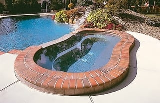 modified-kidney-shape-spa-with-brick-coping.jpg