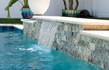 cascade-waterfall-pool-on-stone-backed-pool-wall