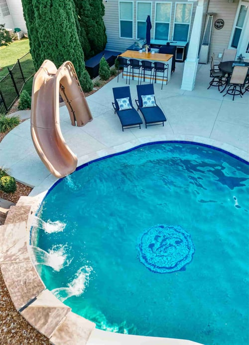 Aerial view of a Blue Haven inground pool with a corkscrew water slide and turquoise water
