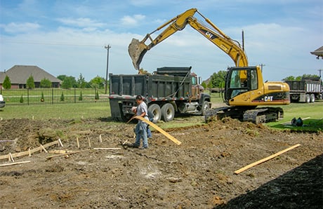 excavator-shoveling-soil-into-dump-truck