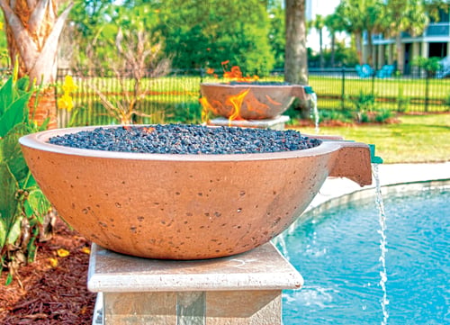poolside fire and water bowl feature on raised pedestal