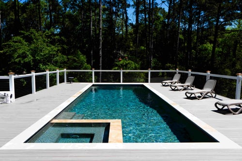 rectangular pool with modern paver decking and contrasting coping