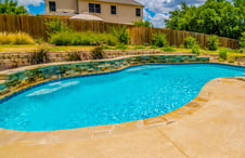free-form-pool-with-stone-clad-raised-wall