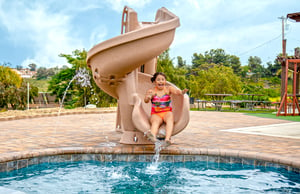girl-on-corkscrew-pool-slide
