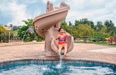 girl-on-corkscrew-pool-slide