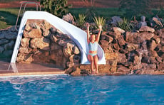 girl-on-pool-slide-integrated-into-rock-waterfall