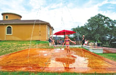 girl-running-through-splash-pad