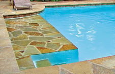inground-pool-with-flagstone-covered-sun-shelf