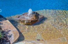 accent-boulder-with-bubbler-fountain-on-pool