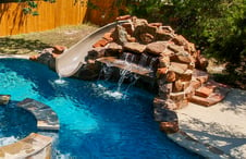 small-grotto-waterfall-slide-on-free-form-pool