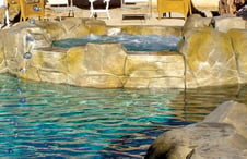 spa-with-fuax-stone-damwall-on-pool