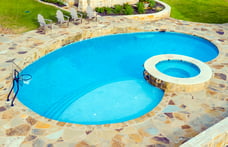 kidney-pool-with-raised-spa-and-flagstone-deck