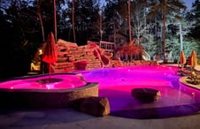lagoon-style-pool-illuminated-in-pink-light