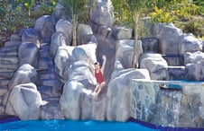 large-pool-rock-waterfall-slide-on-hillside