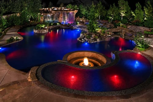 Backyard pool lit red and blue with Bluehaven SmartLight LED for a 4th of July celebration.