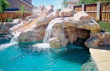 masonry-slide-with-waterfall-grotto-on-pool