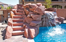  masonry-steps-to slide-on-rock-waterfall-on-pool