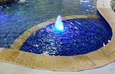 pool step with illuminated bubbler fountain