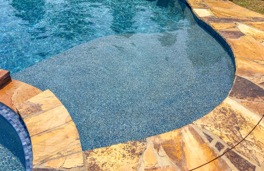 Pool Tanning Ledge With Pebble Interior Flagstone Coping Jpg ?width=900&height=582&name=pool Tanning Ledge With Pebble Interior Flagstone Coping Jpg 