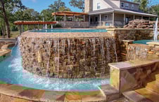 pool-water-flowing-over-stone-infinity-wall-into-catch-basin-4