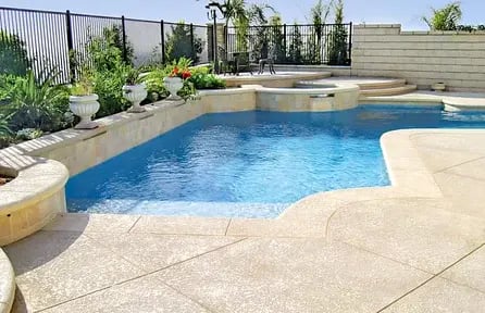 small backyard pool with partial deck layout and open landscaping on one side
