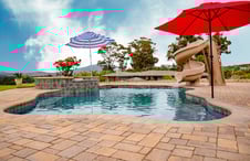 pool-with-slide-and-2-umbrellas-around-perimeter-deck