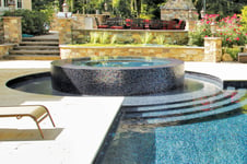 round full-perimeter spa on pool