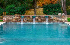 stone-wall-on-pool-with-scupper-style-water-features