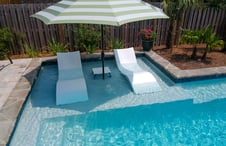 striped-umbrella-on-pool-sun-shelf