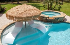 thatch-style-patio-umbrella-on-pool-tanning-ledge-with-chaise-lounges-and-spa