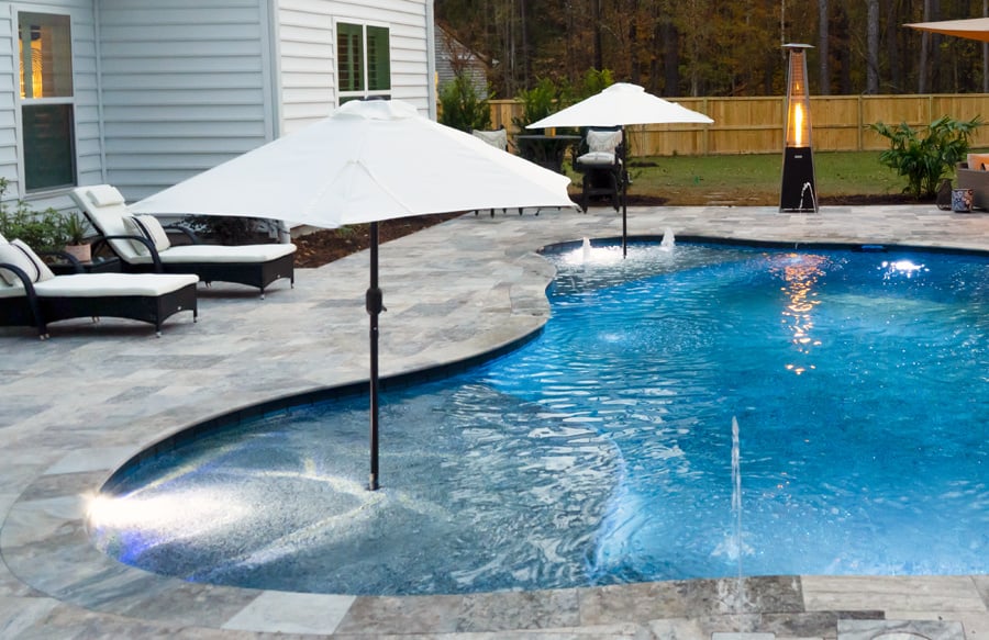 twin-tanning-ledges-with-umbrellas on-swimming-pool