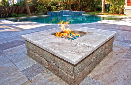Square fire pit with travertine stone and fire glass