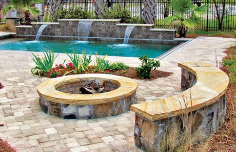 Flagstone fire pit with bench seating wall