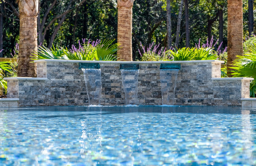 stone-clad-pool-feature-wall-wide-scupper-fountains